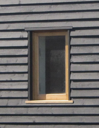 Timber window in timber boarding